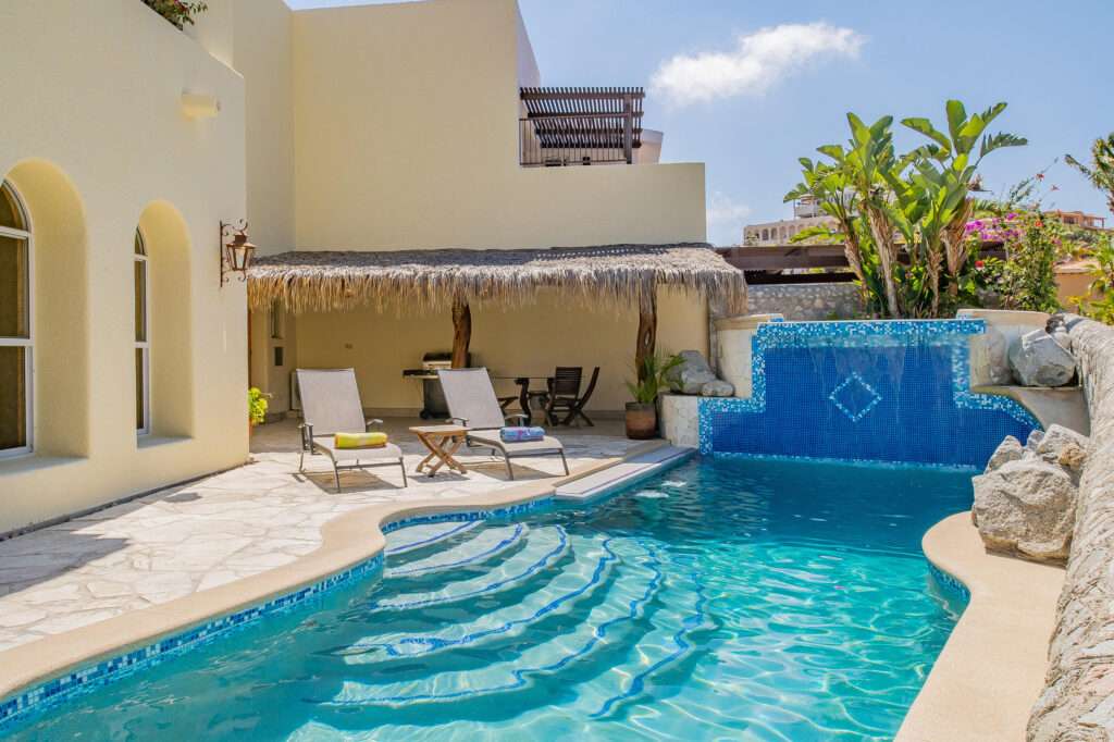 Los Cabos Blue Moon Located in the prestigious gated community of Pedregal, Villa De La Luz offers timeless Mexican Hacienda architecture combined with spacious living and exceptional comfort.This beautifully designed residence features expansive indoor and outdoor areas, ideal for both full-time living and entertaining. Bright interiors flow seamlessly to generous terraces, creating the perfect setting to enjoy Cabo's lifestyle.The home offers 6 en-suite bedrooms, a fully equipped kitchen, and thoughtfully designed living spaces. Outdoor amenities include a private swimming pool, jacuzzi, and BBQ area, providing an ideal environment for relaxation and gatherings.Include a two-car garage, ample storage, and access to Pedregal's exclusive amenities, including 24/7 security, beach and green areas. – 275 Camino del Mar, Cabo San Lucas, BS